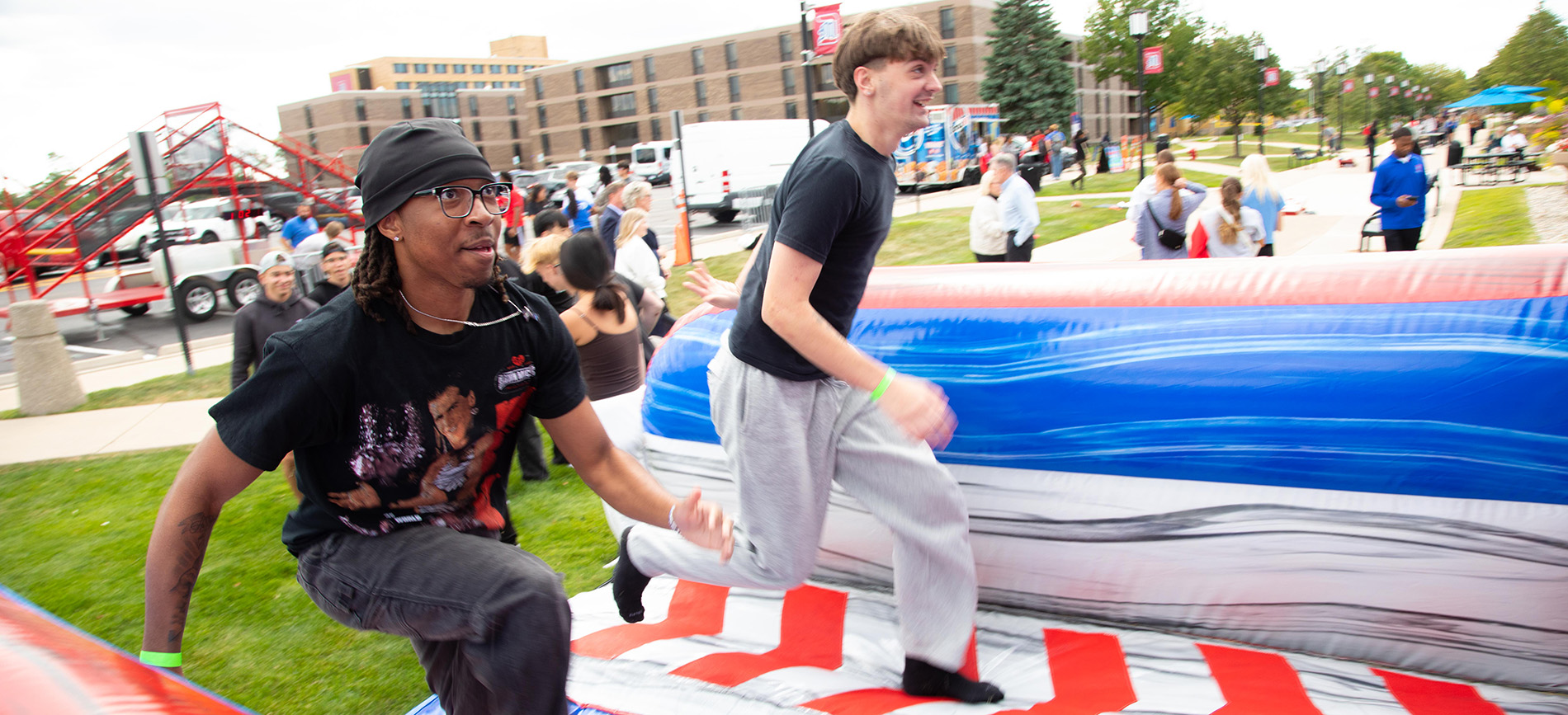 Students run on a bounce house blowup during a Rec Fest.