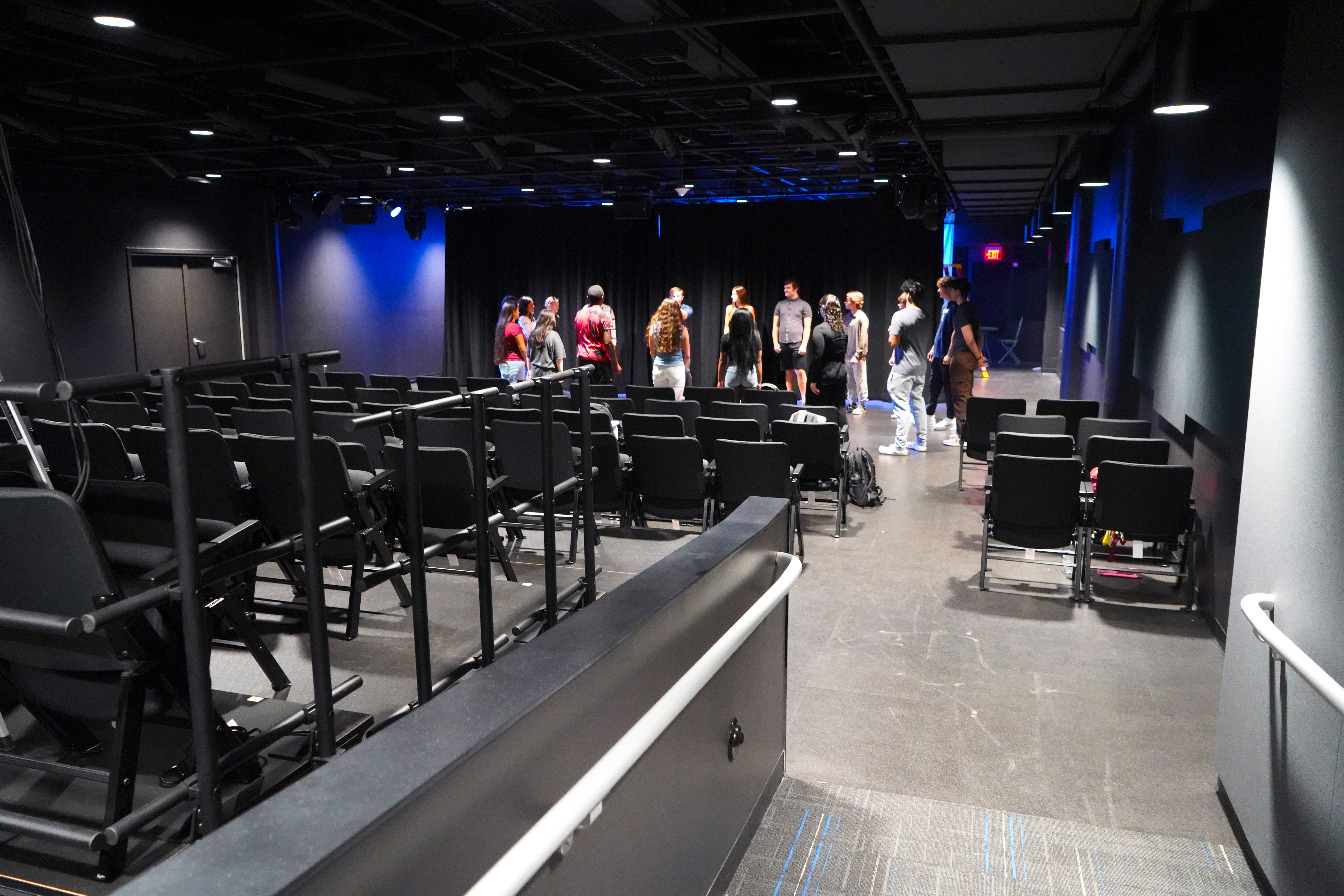 The entrance to Detroit Mercy Black Box THeatre. A group of students learning in the background
