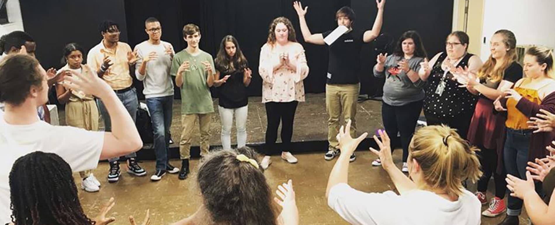 Classroom activity of students standing together in a circle