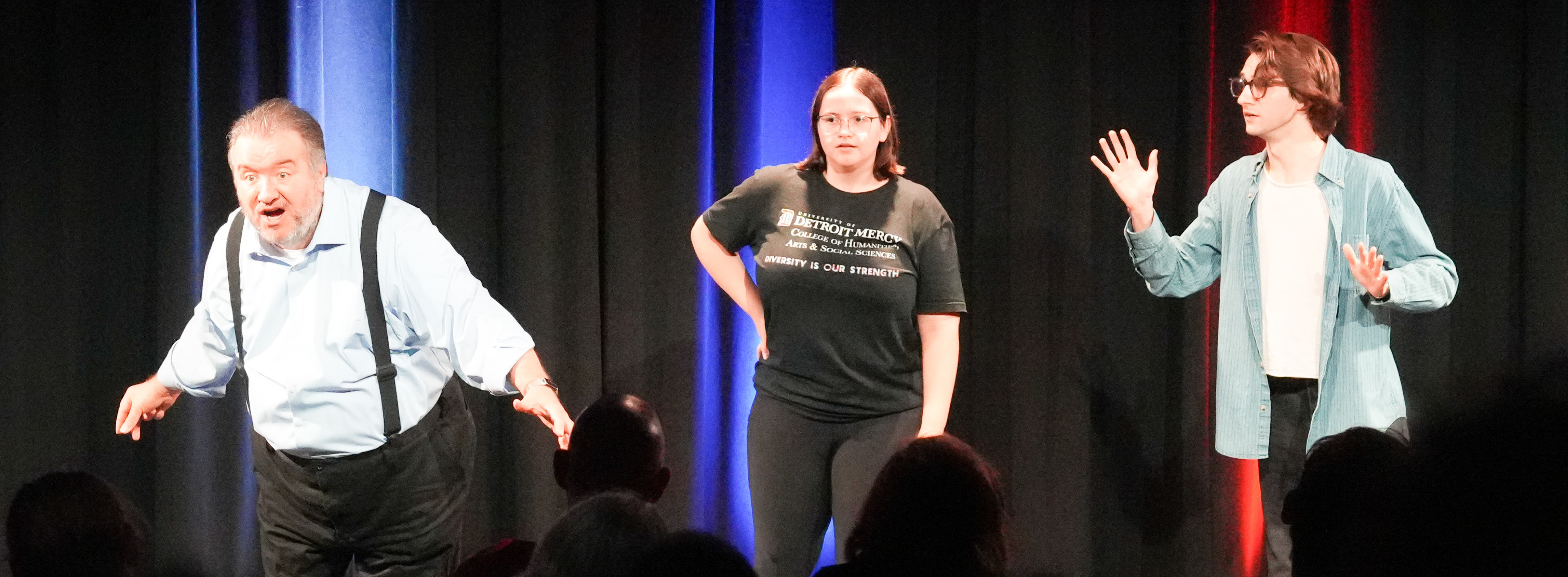 Three people doing theatre