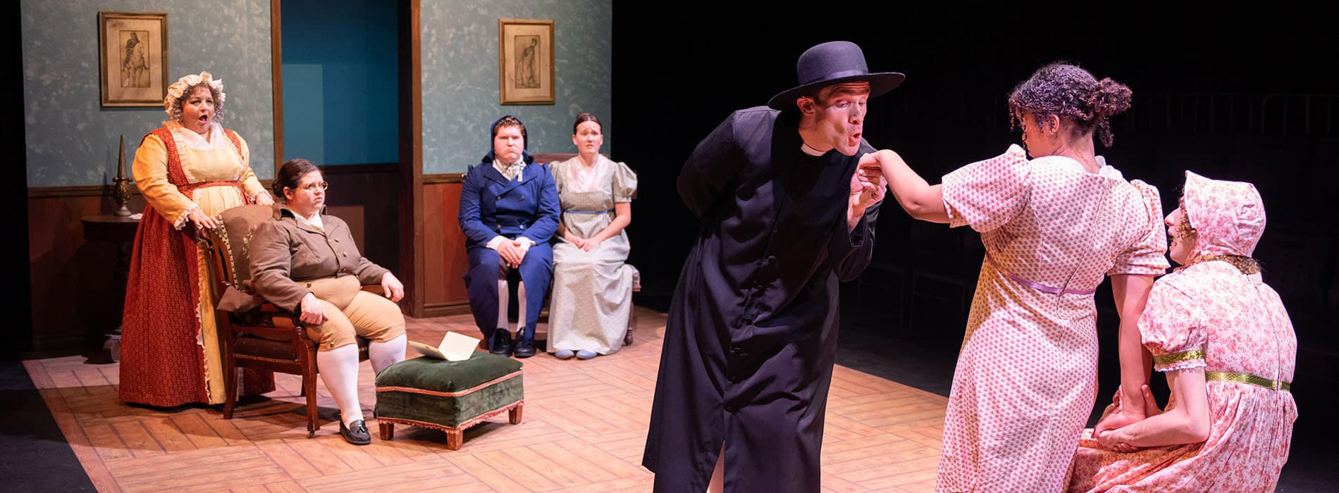 Pride & Prejudice banner with actors and actresses in a scene on stage