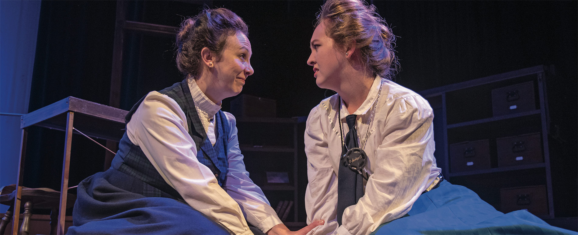 Two women on stage during a theatre production