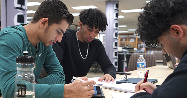 group of students studying together in the library