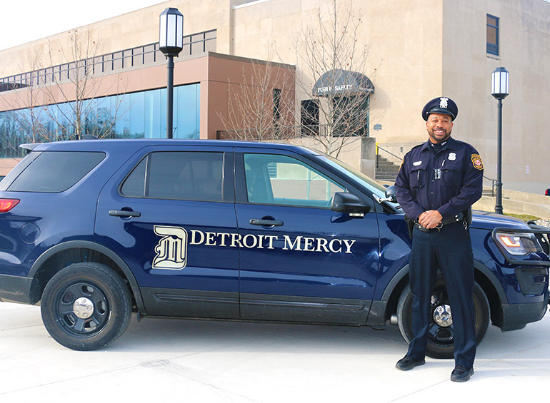 public safety officer by his car